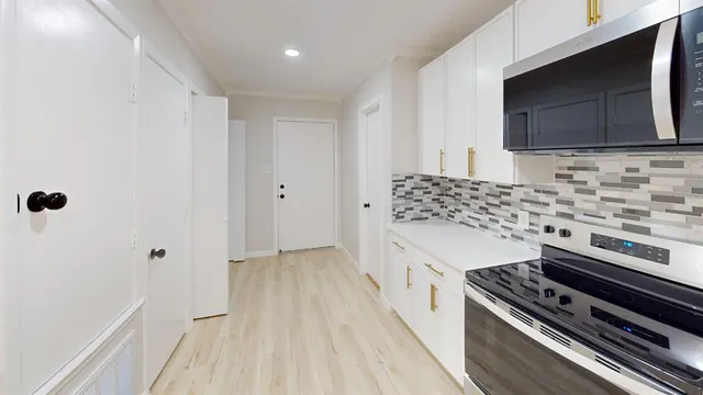 a kitchen with a stove and a microwave