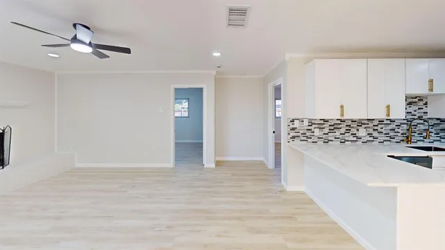 a view of kitchen with sink and refrigerator