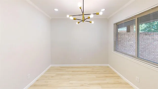 a view of a room with a ceiling fan and a window