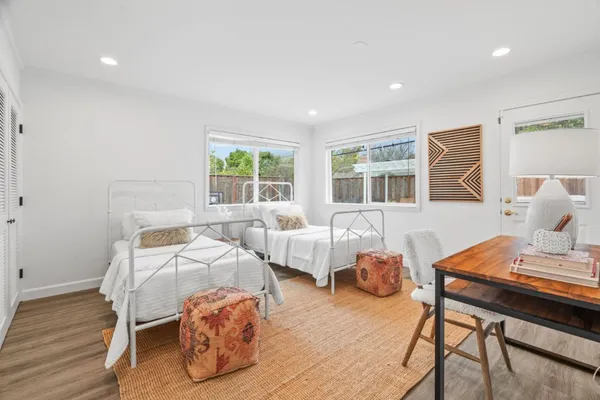 a bedroom with furniture and a wooden floor
