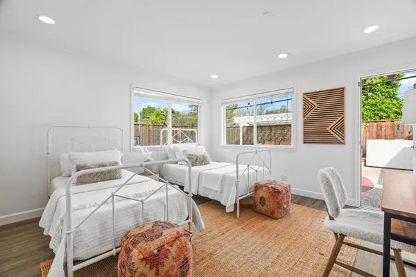 a bedroom with two beds and a large window