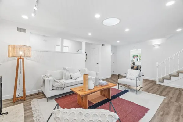 a living room with furniture and a lamp