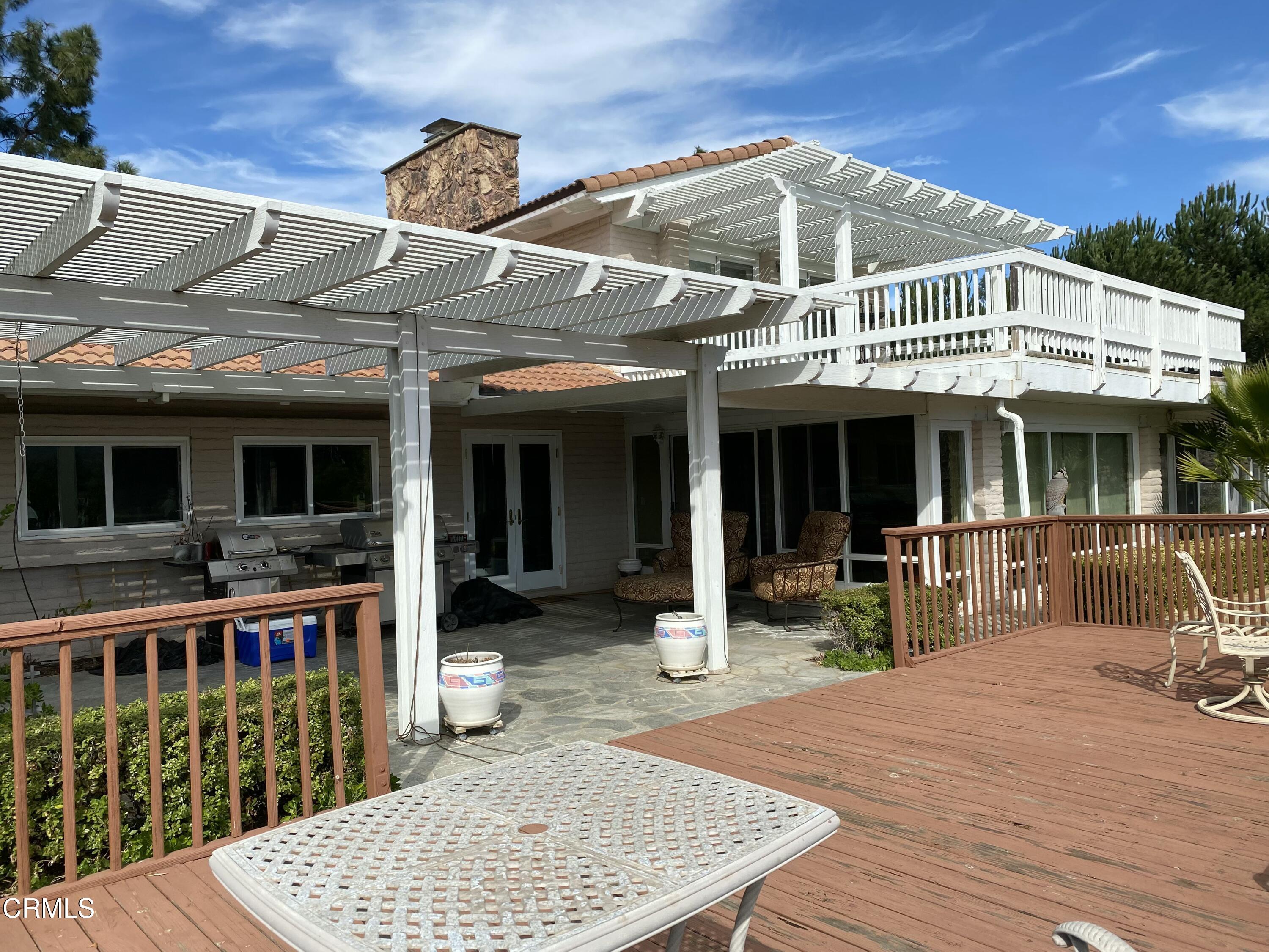 a front view of a house with outdoor seating
