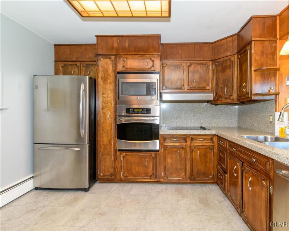 405 Moorestown Drive Bath, PA 18014 - Photo 3 of 50 a kitchen with stainless steel appliances granite countertop a refrigerator and a sink