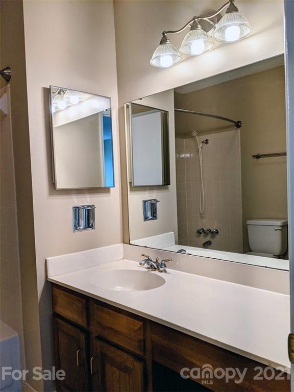 1608 Sharon Road West, Unit 48 Charlotte, NC 28210 - Photo 11 of 15 a bathroom with a sink and a mirror