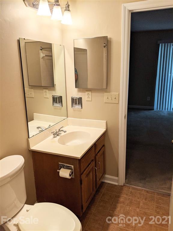 1608 Sharon Road West, Unit 48 Charlotte, NC 28210 - Photo 15 of 15 a bathroom with a sink toilet and mirror