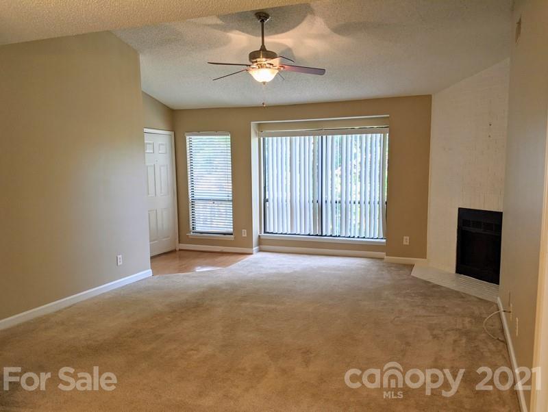 1608 Sharon Road West, Unit 48 Charlotte, NC 28210 - Photo 5 of 15 a view of an empty room with a window