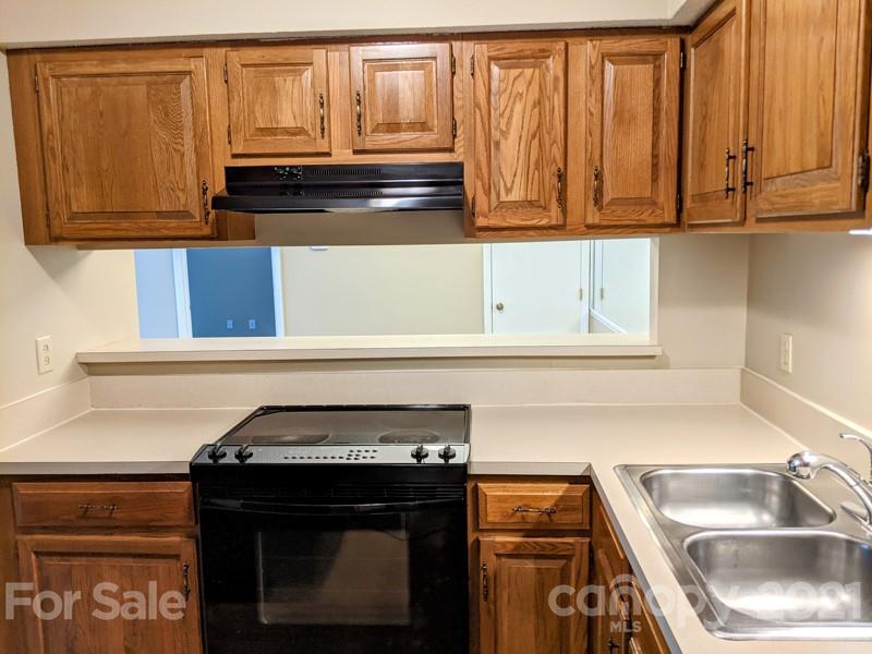 1608 Sharon Road West, Unit 48 Charlotte, NC 28210 - Photo 8 of 15 a kitchen with granite countertop a sink and a stove