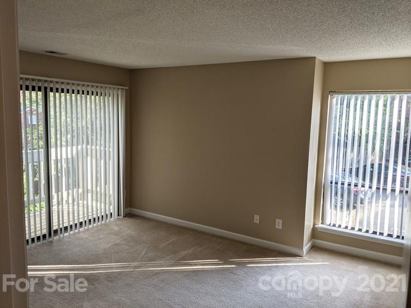 1608 Sharon Road West, Unit 48 Charlotte, NC 28210 - Photo 9 of 15 a view of an empty room with a window