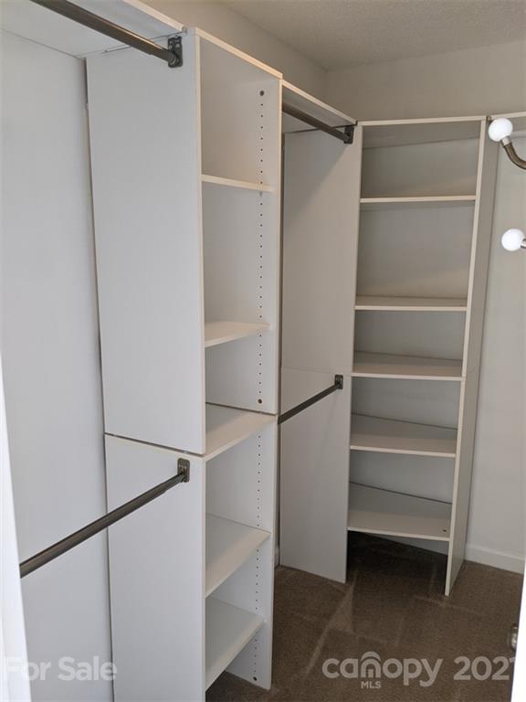 1608 Sharon Road West, Unit 48 Charlotte, NC 28210 - Photo 10 of 15 a view of walk in closet with empty racks