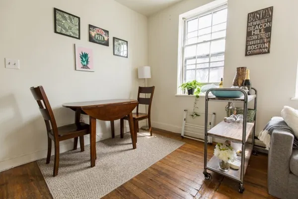 a view of a dining room with furniture and wooden floor