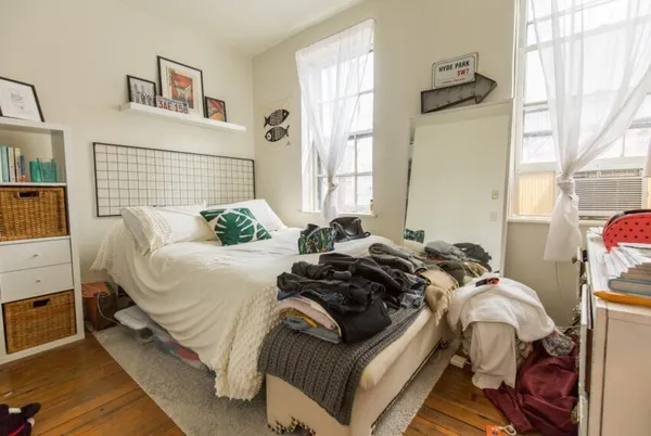 a bedroom with a bed and a window