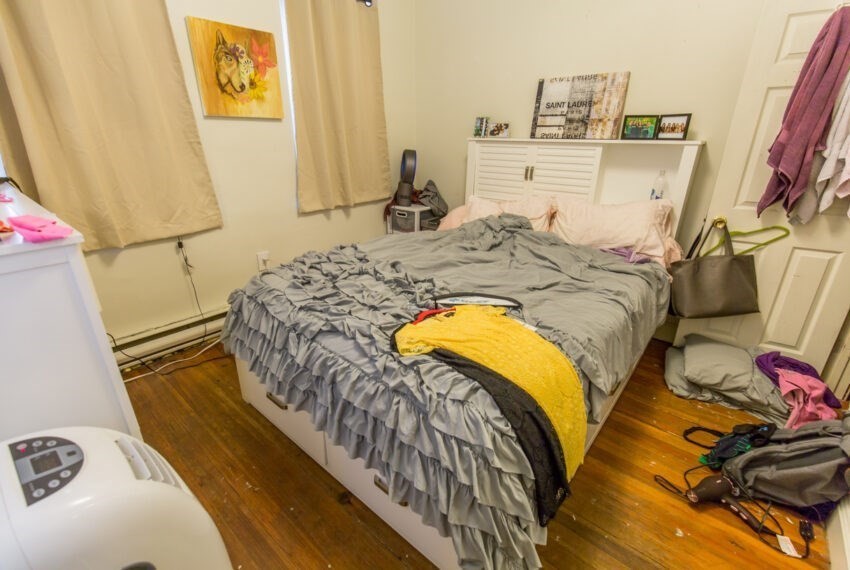 11 Phillips Street, Unit 5 Boston, MA 02114 - Photo 13 of 17 a bed sitting in a bedroom next to a window