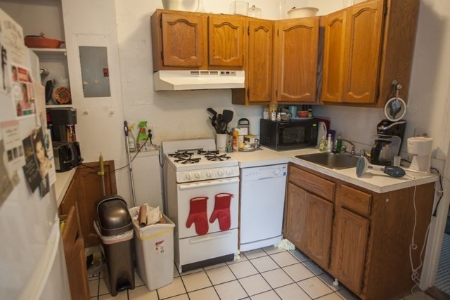 11 Phillips Street, Unit 5 Boston, MA 02114 - Photo 5 of 17 a kitchen with stainless steel appliances granite countertop a sink stove and cabinets