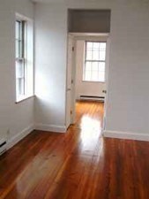 11 Phillips Street, Unit 5 Boston, MA 02114 - Photo 7 of 17 an empty room with wooden floor and windows