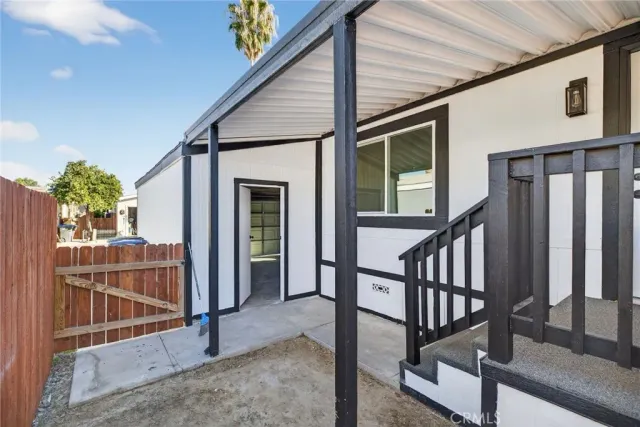 a view of staircase with railing and white walls