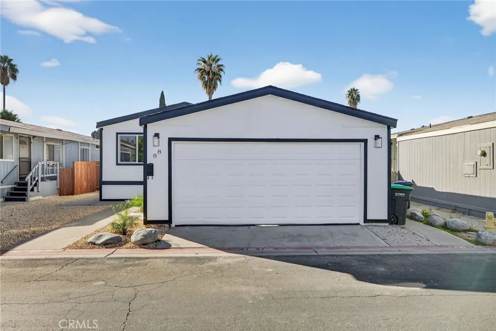 80 Dawes, Unit 88 Perris, CA 92571 - Photo 2 of 29 a front view of a house with a yard and garage