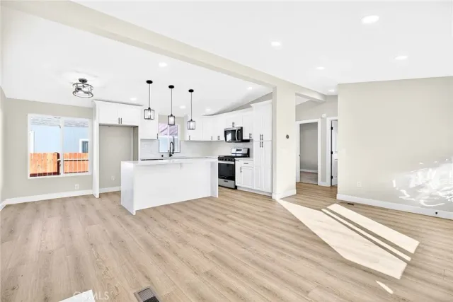 a view of a kitchen with a sink and cabinet