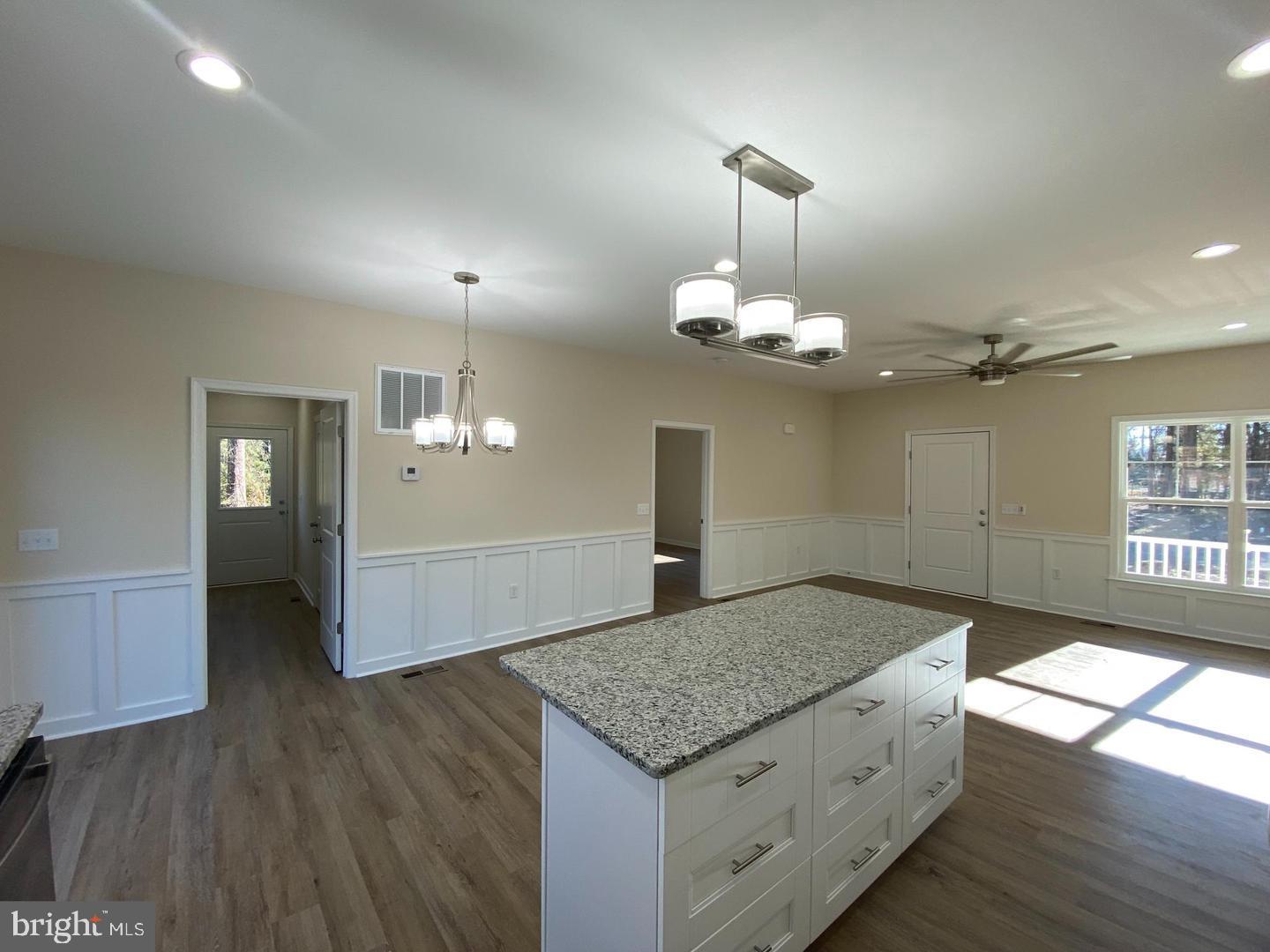 121 North Glebe Road Montross, VA 22520 - Photo 3 of 4 a kitchen with a sink chandelier and wooden floor