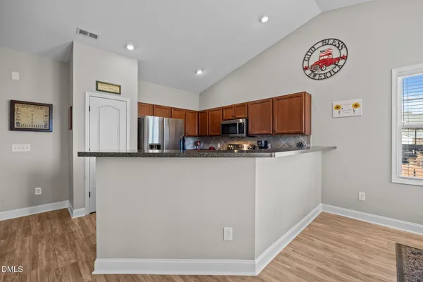 a kitchen with stainless steel appliances granite countertop a sink stove and microwave
