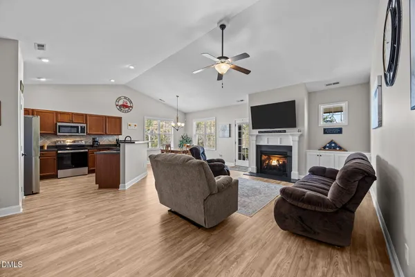 a kitchen with granite countertop a stove sink and microwave