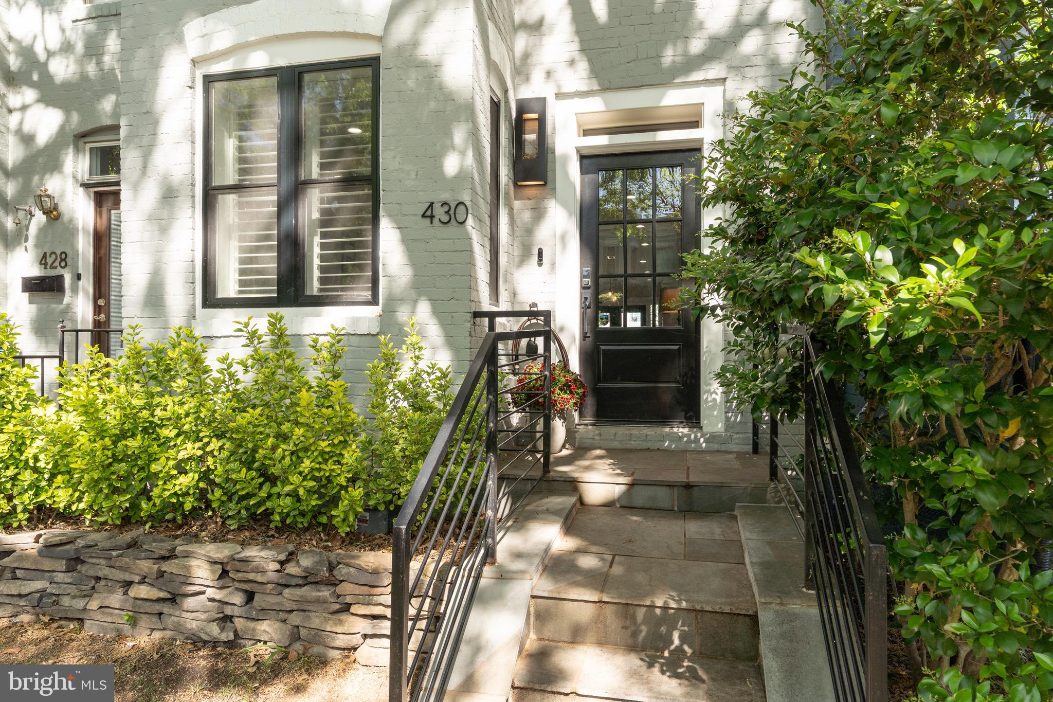 430 15th Street Southeast Washington, DC 20003 - Photo 2 of 8 a view of a brick house with a large windows and flower plants