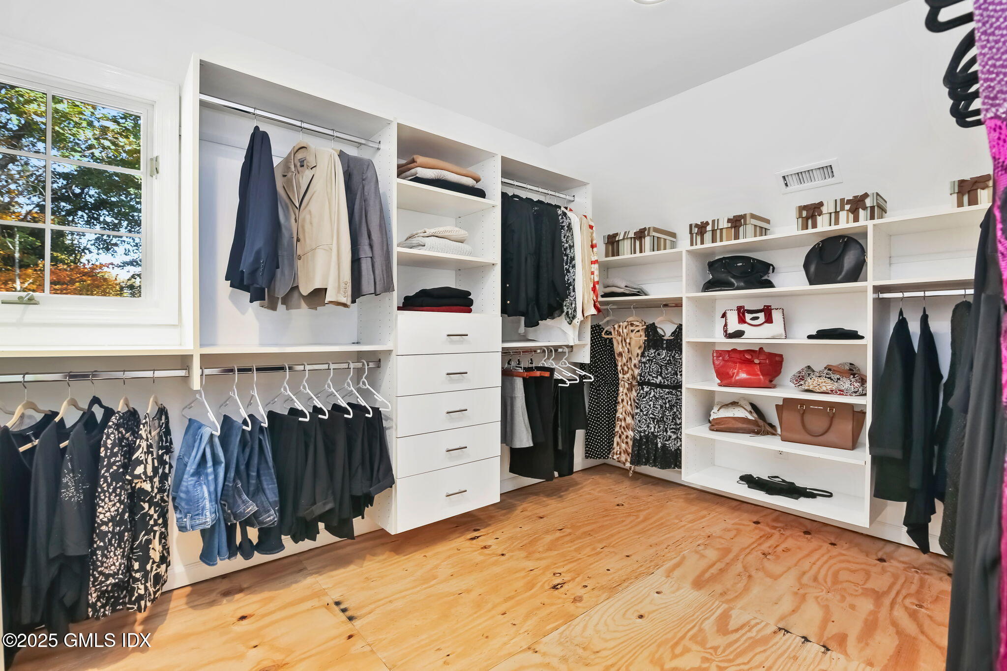 73 Weaver Street, Unit 4 Greenwich, CT 06831 - Photo 16 of 30 a view of walk in closet with clothes and shoes