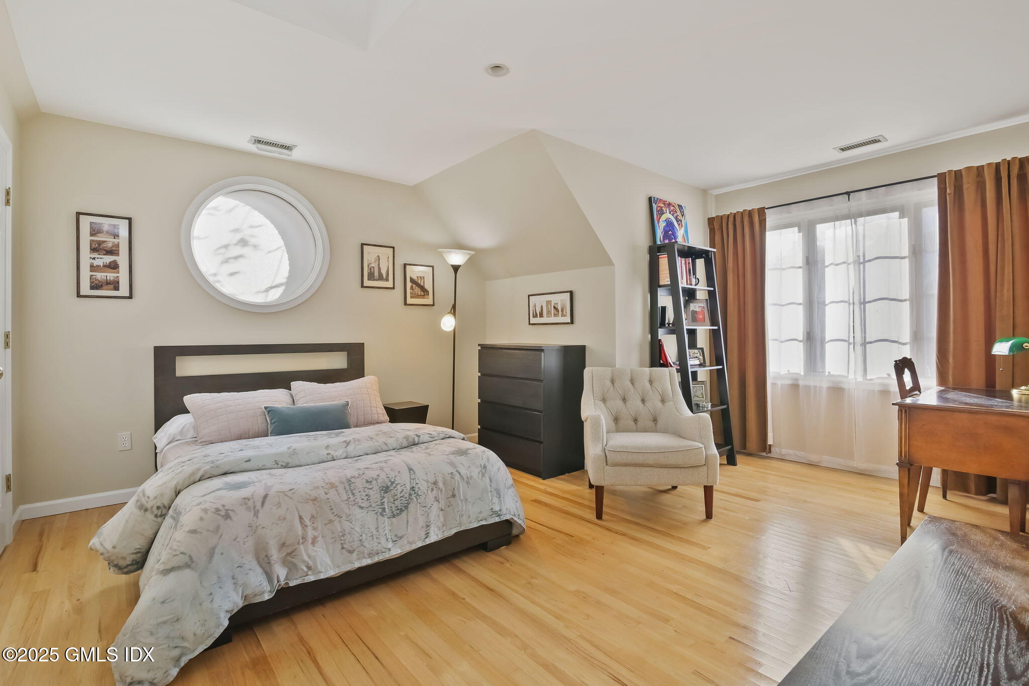 73 Weaver Street, Unit 4 Greenwich, CT 06831 - Photo 17 of 30 a bedroom with a bed and a table in it with wooden floor