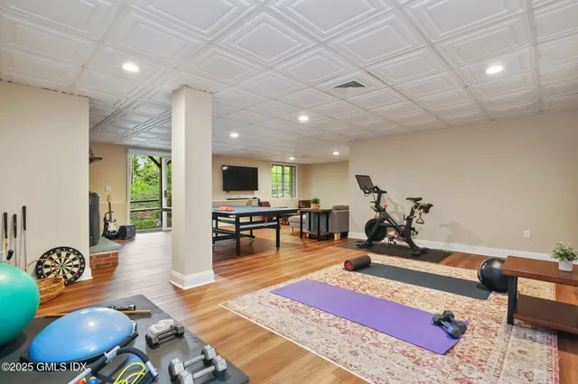 a living room with furniture a rug and a flat screen tv