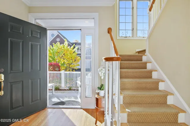a view of entryway with wooden floor and windows