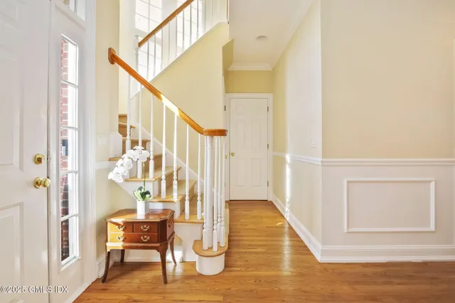 a view of entryway and hall with wooden floor