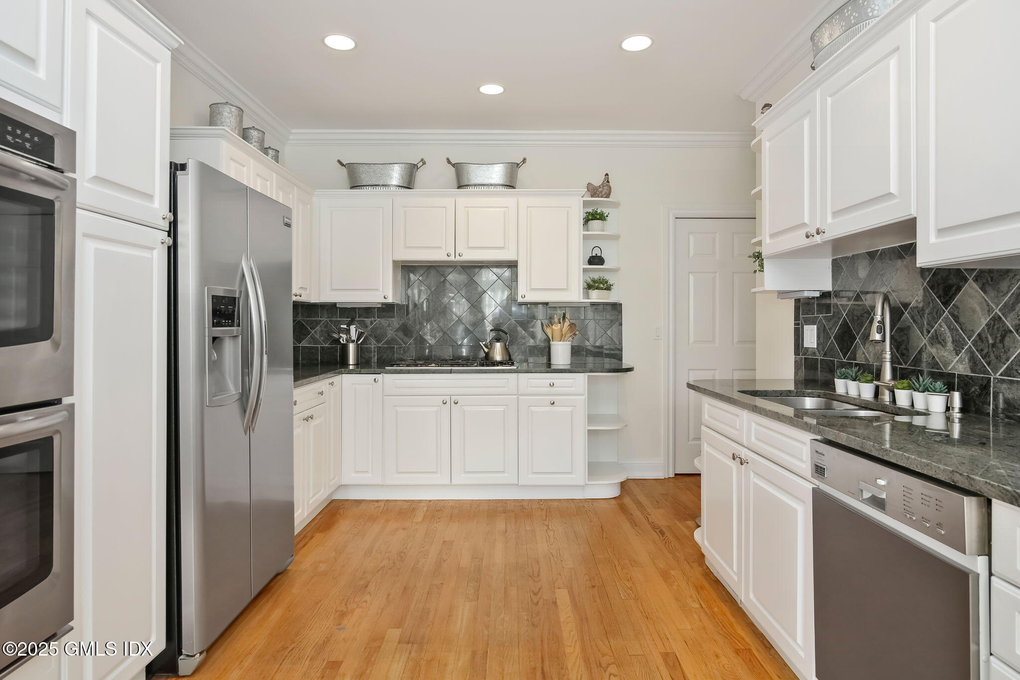 73 Weaver Street, Unit 4 Greenwich, CT 06831 - Photo 6 of 30 a kitchen with stainless steel appliances a refrigerator sink and white cabinets