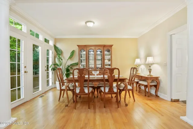 a view of a dining room with furniture window and wooden floor