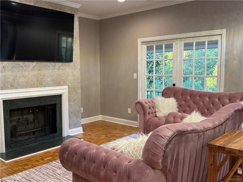 3508 Paces Place Northwest Atlanta, GA 30327 - Photo 12 of 25 a living room with a couch a fireplace and a flat screen tv