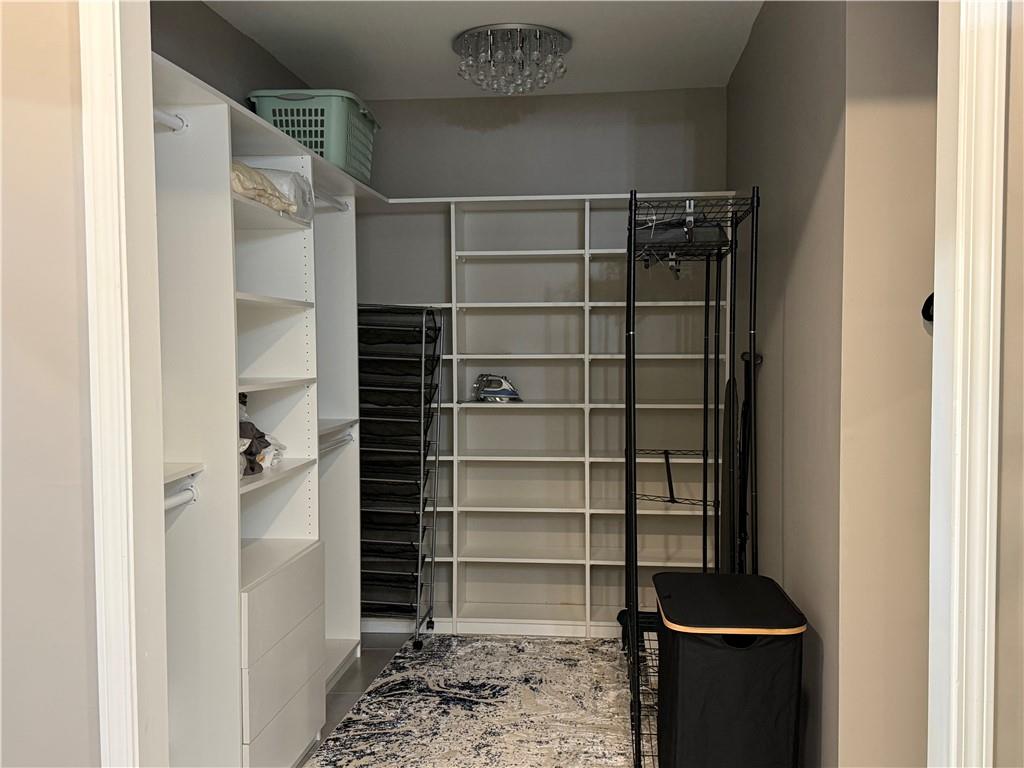 3508 Paces Place Northwest Atlanta, GA 30327 - Photo 21 of 25 a view of walk in closet with empty racks