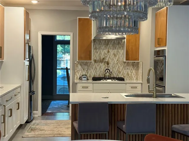 a kitchen with stainless steel appliances granite countertop a sink and a window
