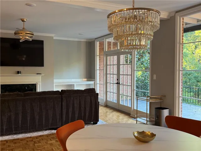 a view of a dining room with furniture and chandelier