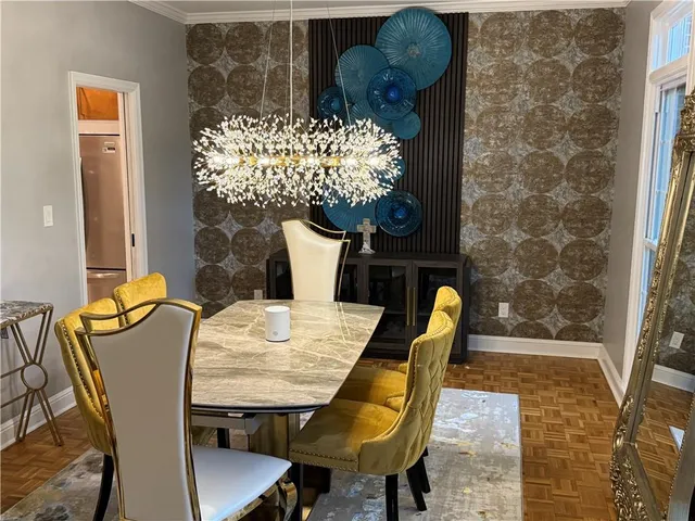 a dining room with furniture and wooden floor