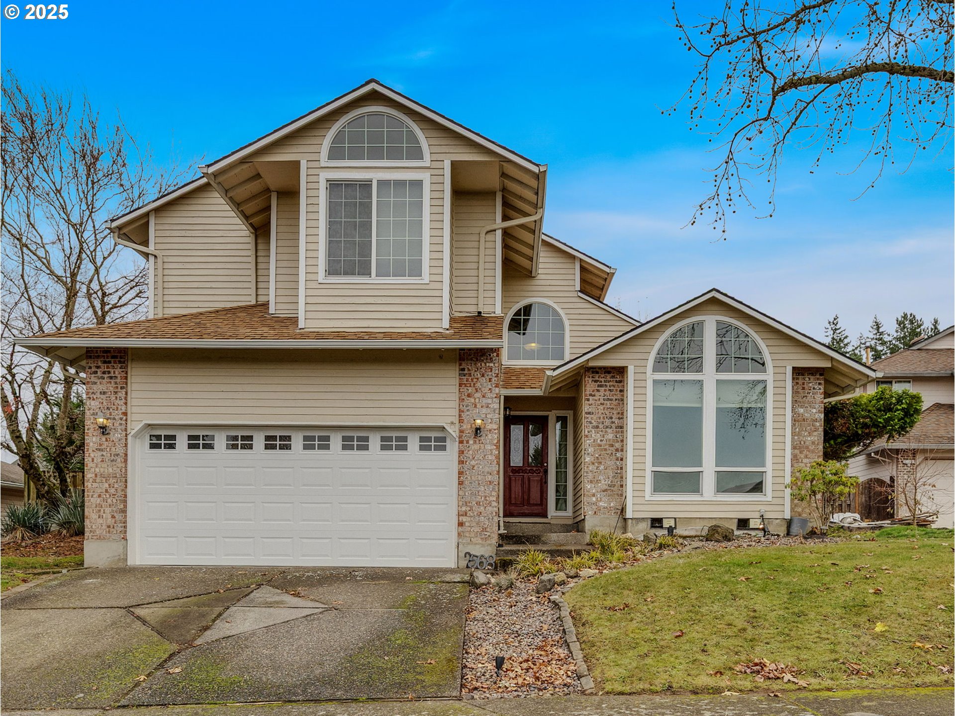 2568 Southwest Orchard Court Gresham, OR 97080 - Photo 1 of 46 a front view of a house with a yard