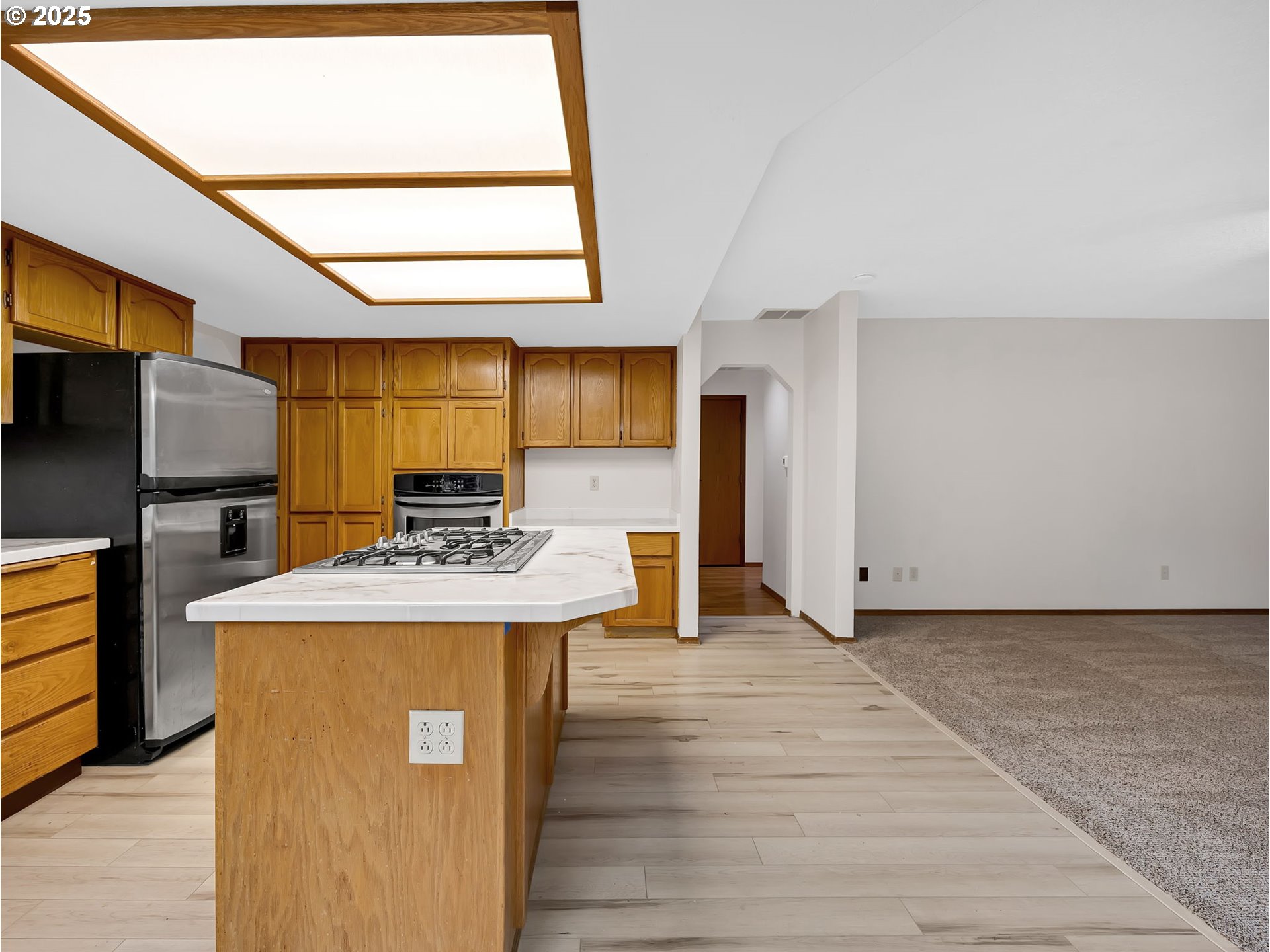 2568 Southwest Orchard Court Gresham, OR 97080 - Photo 11 of 46 a kitchen with stainless steel appliances granite countertop a sink a stove and a refrigerator