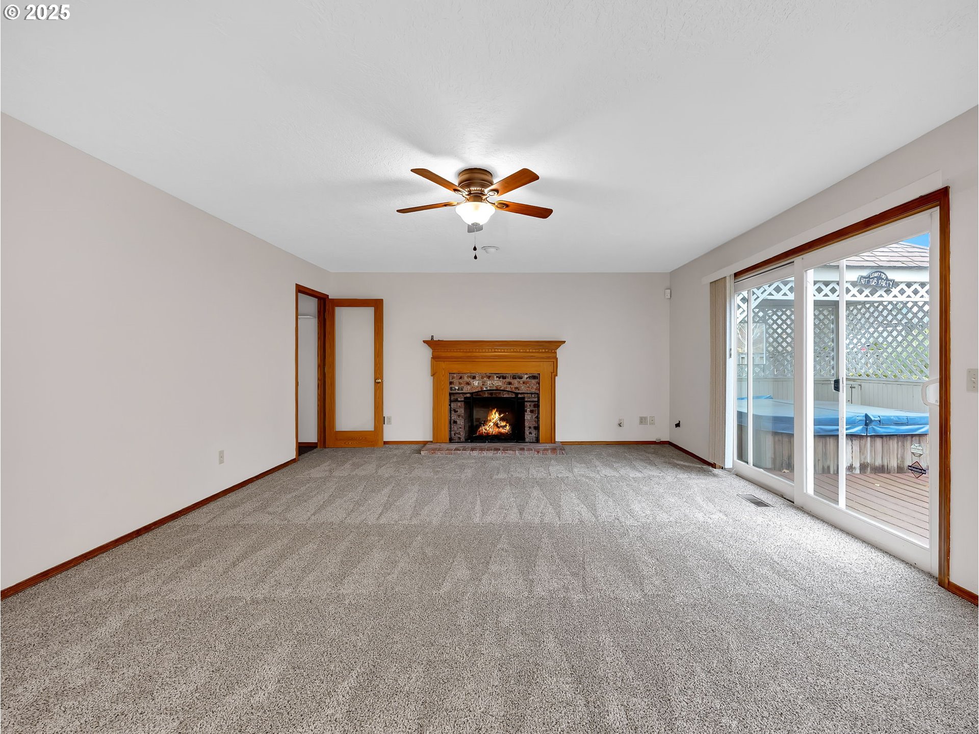 2568 Southwest Orchard Court Gresham, OR 97080 - Photo 12 of 46 a view of an empty room with a fireplace and a window