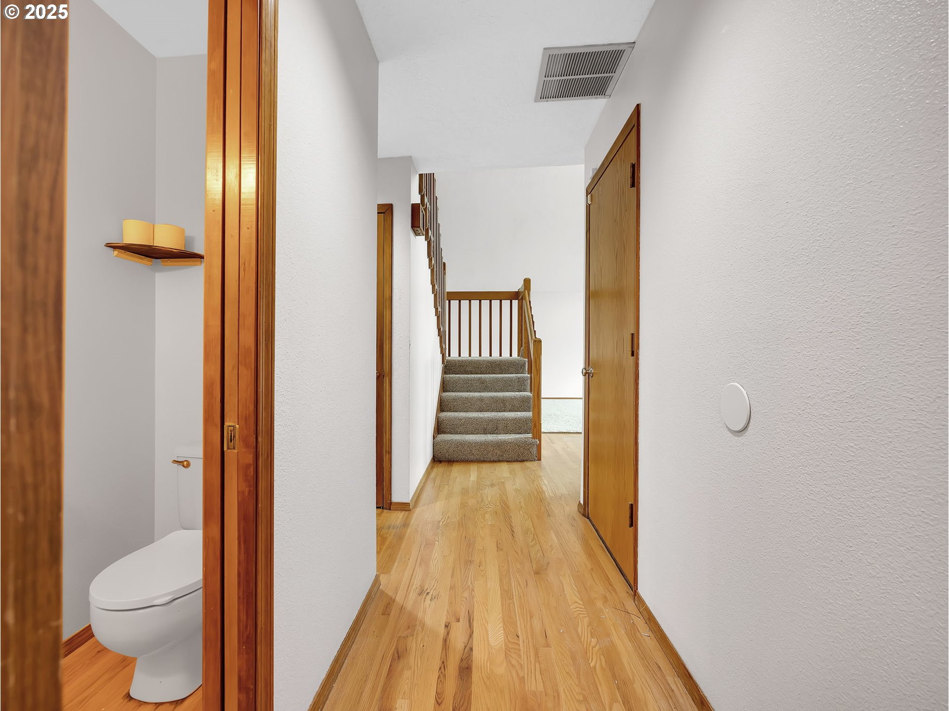 2568 Southwest Orchard Court Gresham, OR 97080 - Photo 16 of 46 a view of a hallway with wooden floor and bathroom