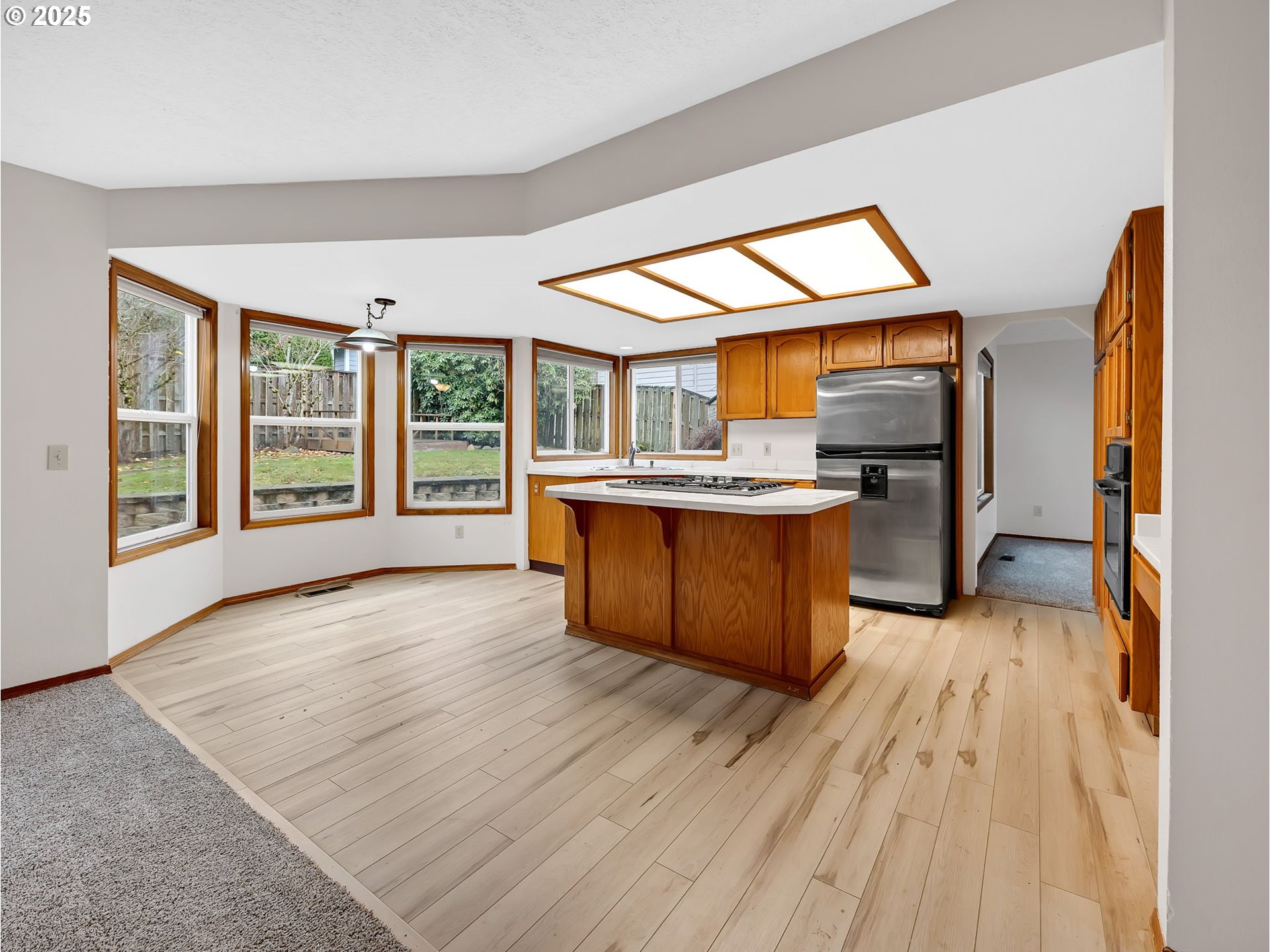 2568 Southwest Orchard Court Gresham, OR 97080 - Photo 7 of 46 a kitchen with stainless steel appliances granite countertop a stove and wooden floor