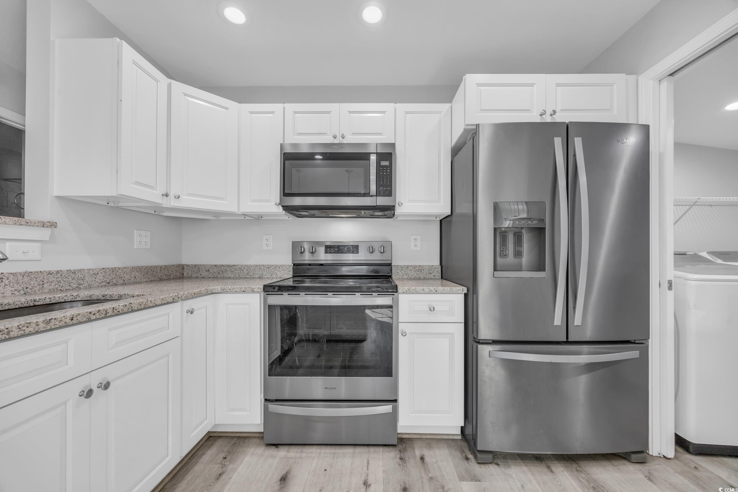 607 Jefferson Way Conway, SC 29526 - Photo 12 of 28 Kitchen with white cabinetry, light wood-type floo
