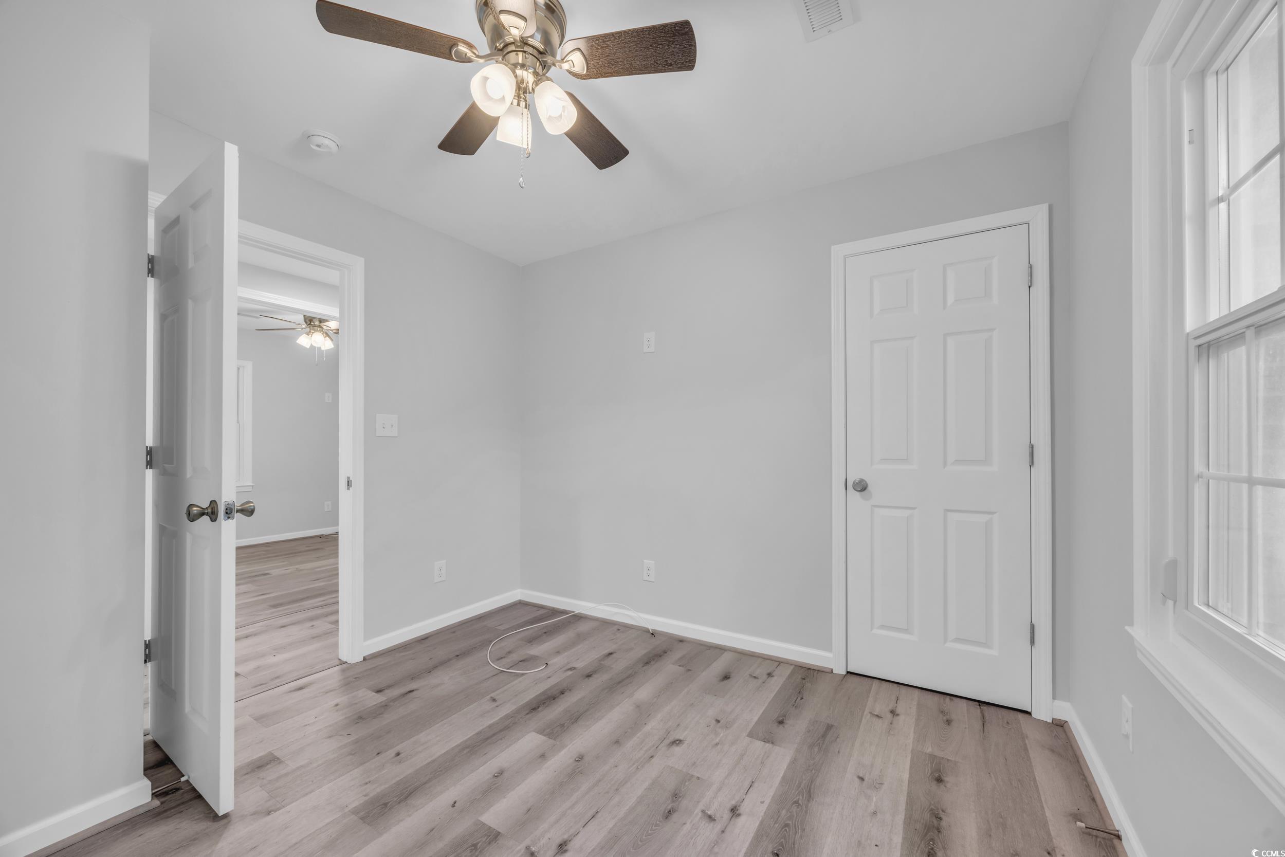 607 Jefferson Way Conway, SC 29526 - Photo 15 of 28 Unfurnished bedroom with ceiling fan and light har