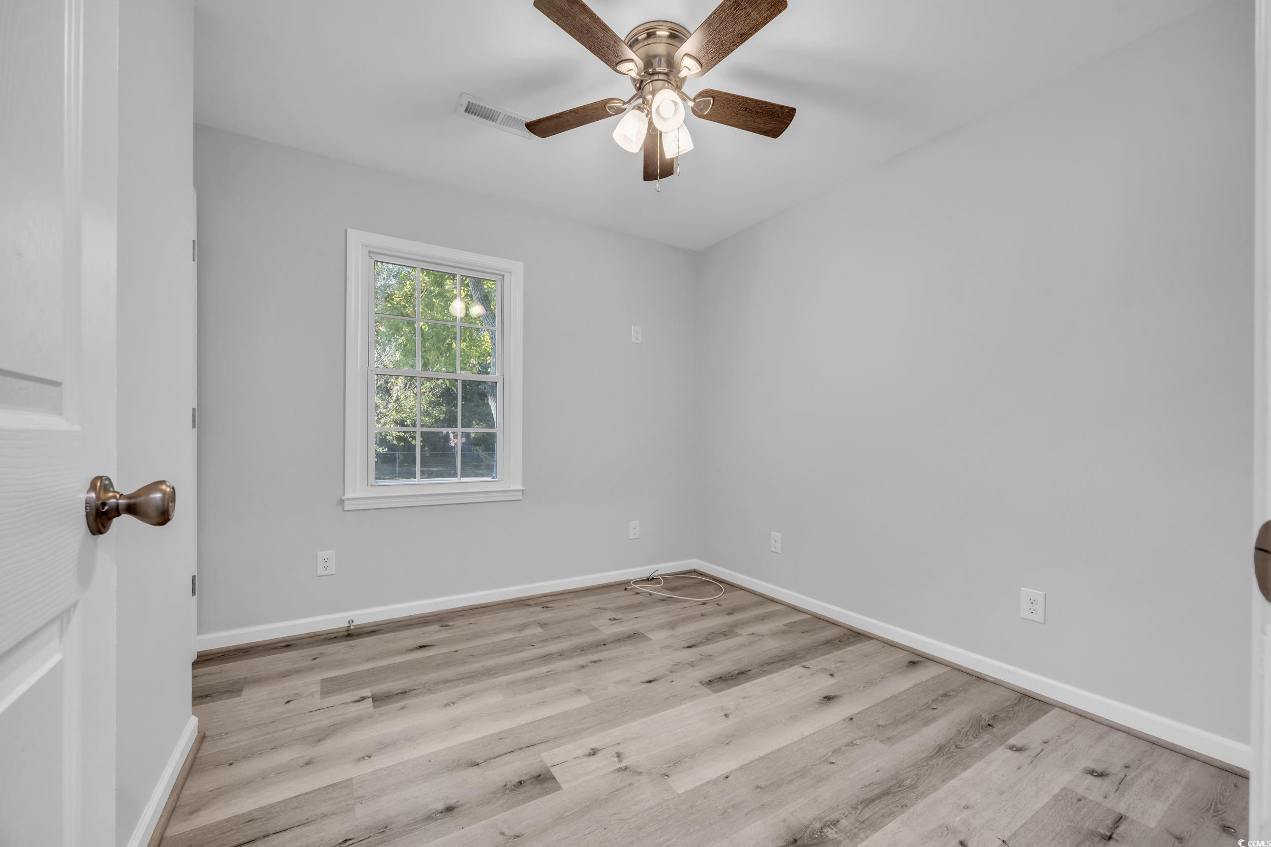 607 Jefferson Way Conway, SC 29526 - Photo 16 of 28 Empty room with ceiling fan and light hardwood / w