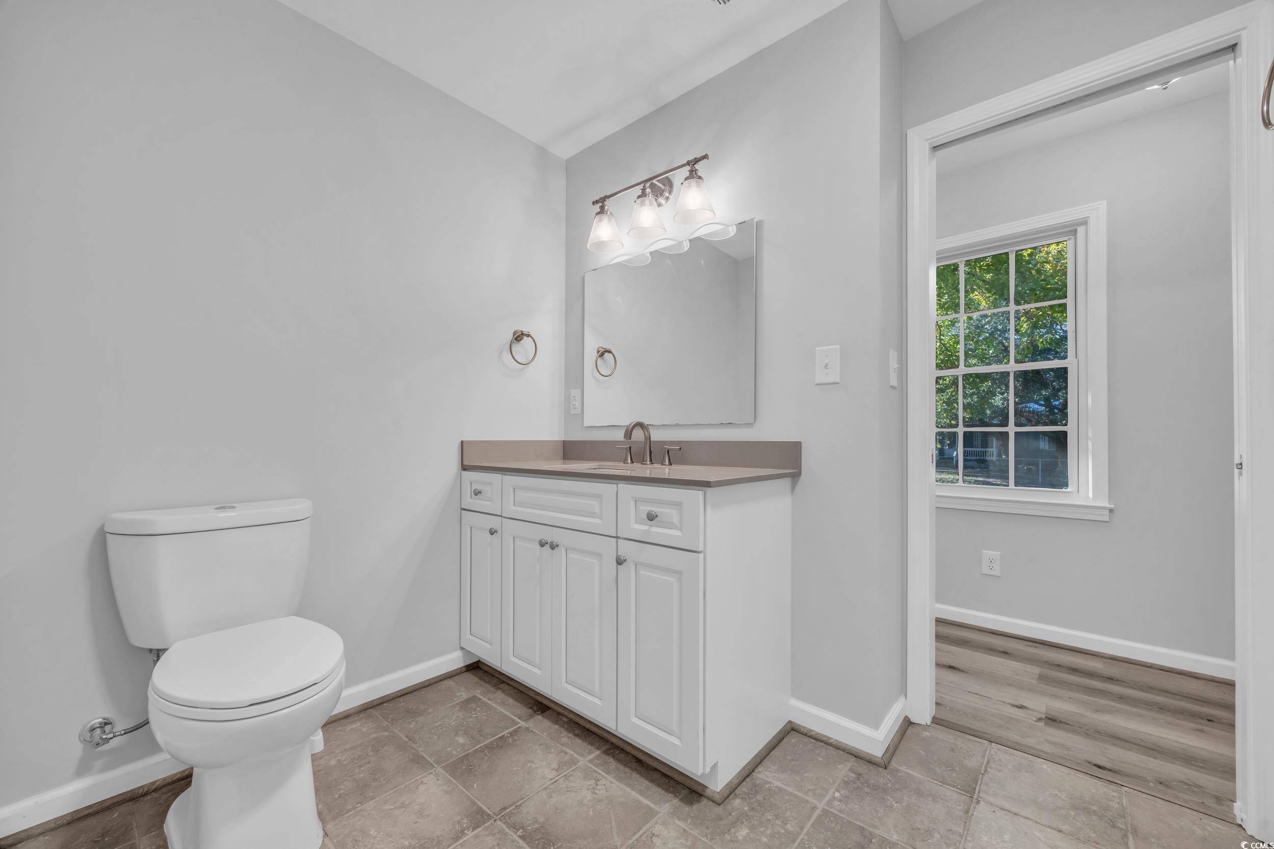 607 Jefferson Way Conway, SC 29526 - Photo 21 of 28 Bathroom with toilet, vanity, and wood-type floori