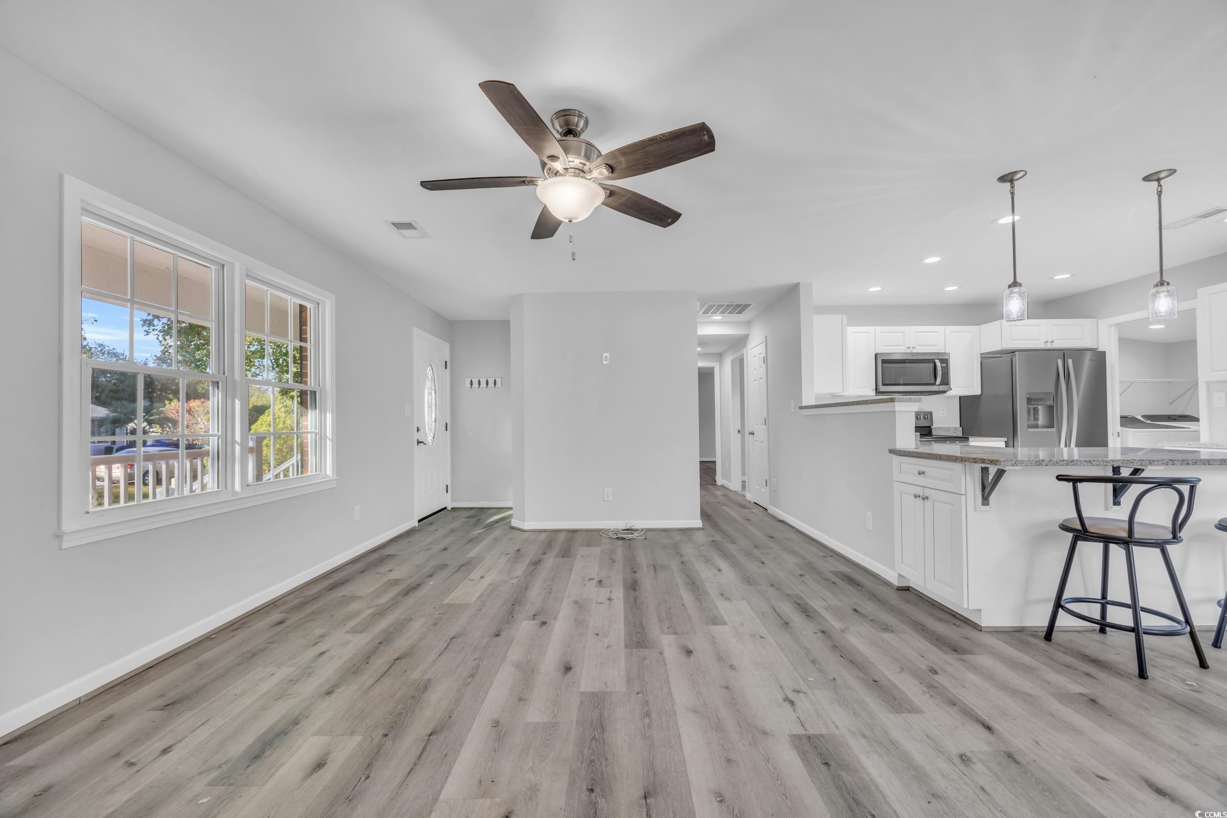 607 Jefferson Way Conway, SC 29526 - Photo 3 of 28 Unfurnished living room with light hardwood / wood