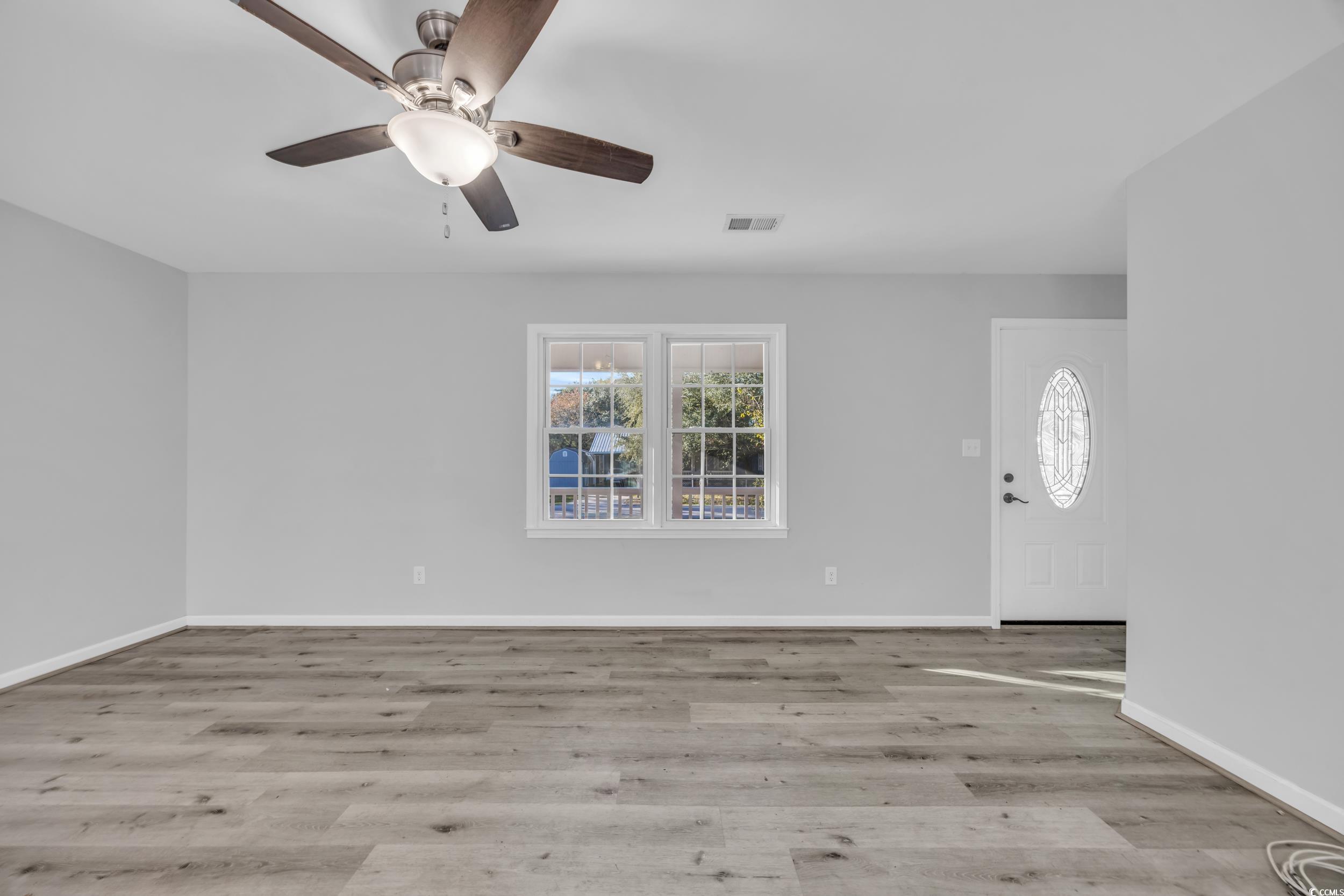 607 Jefferson Way Conway, SC 29526 - Photo 8 of 28 Empty room featuring light hardwood / wood-style f