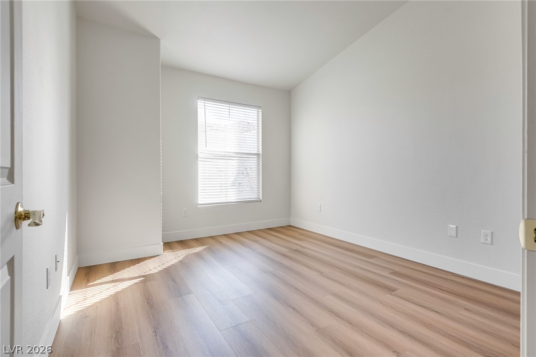 10550 West Alexander Road, Unit 2174 Las Vegas, NV 89129 - Photo 19 of 28 Smooth wood floors and vaulted ceilings create an inviting and open atmosphere.